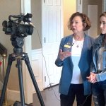 An image of Marilyn Lands speaking in front of a video camera with supporter Alyssa Gonzales.