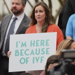 Sarah Brown, a Birmingham resident and in vitro fertilization patient, holds a sign at the Alabama Statehouse on Feb. 28, 2024