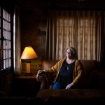 Cheryl Thompson sits for a portrait near a window.