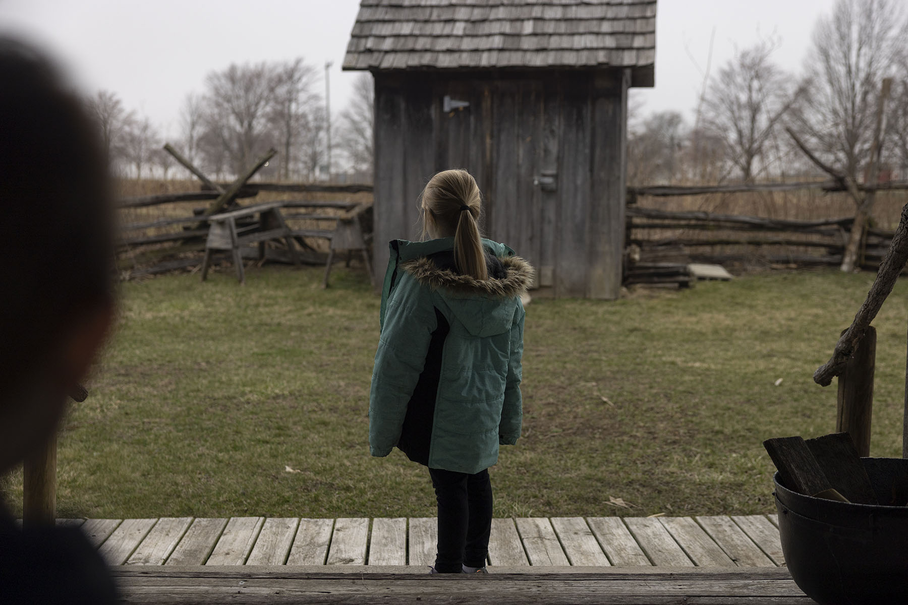 The little girl stands alone in a park.