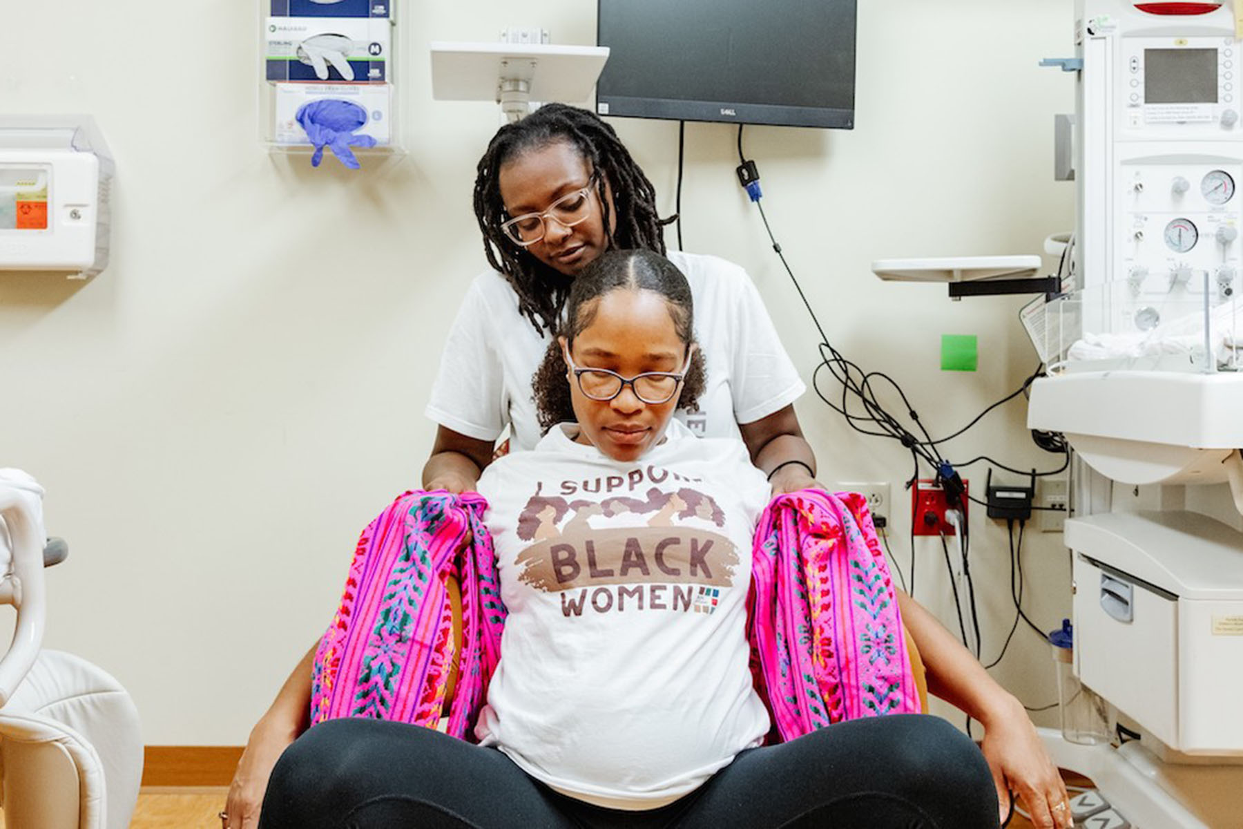 Doulas with Birth in Color participate in a doula simulation training session.