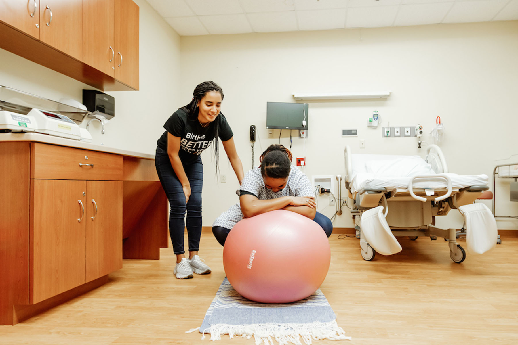 Doulas with Birth in Color, participate in a doula simulation training session.