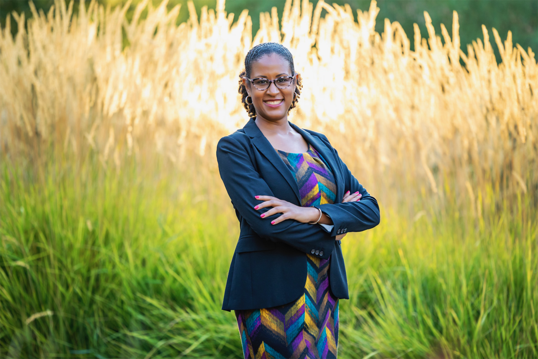 Portrait of Jade Sasser smiling near a field.