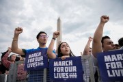 Demonstrators hold their fists up as they chant during a March for Our Lives rally against gun violence on the National Mall.