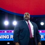 Mark Robinson stands on stage at CPAC.