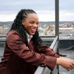 Rep. Summer Lee laughs as she stands for a portrait on a rooftop overlooking the East Liberty neighborhood of Pittsburgh.