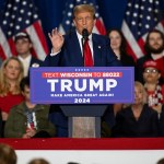 Donald Trump speaks at a campaign rally in Wisconsin on April 2. He's standing behind a lectern with his name on it, with people and American flags in the background