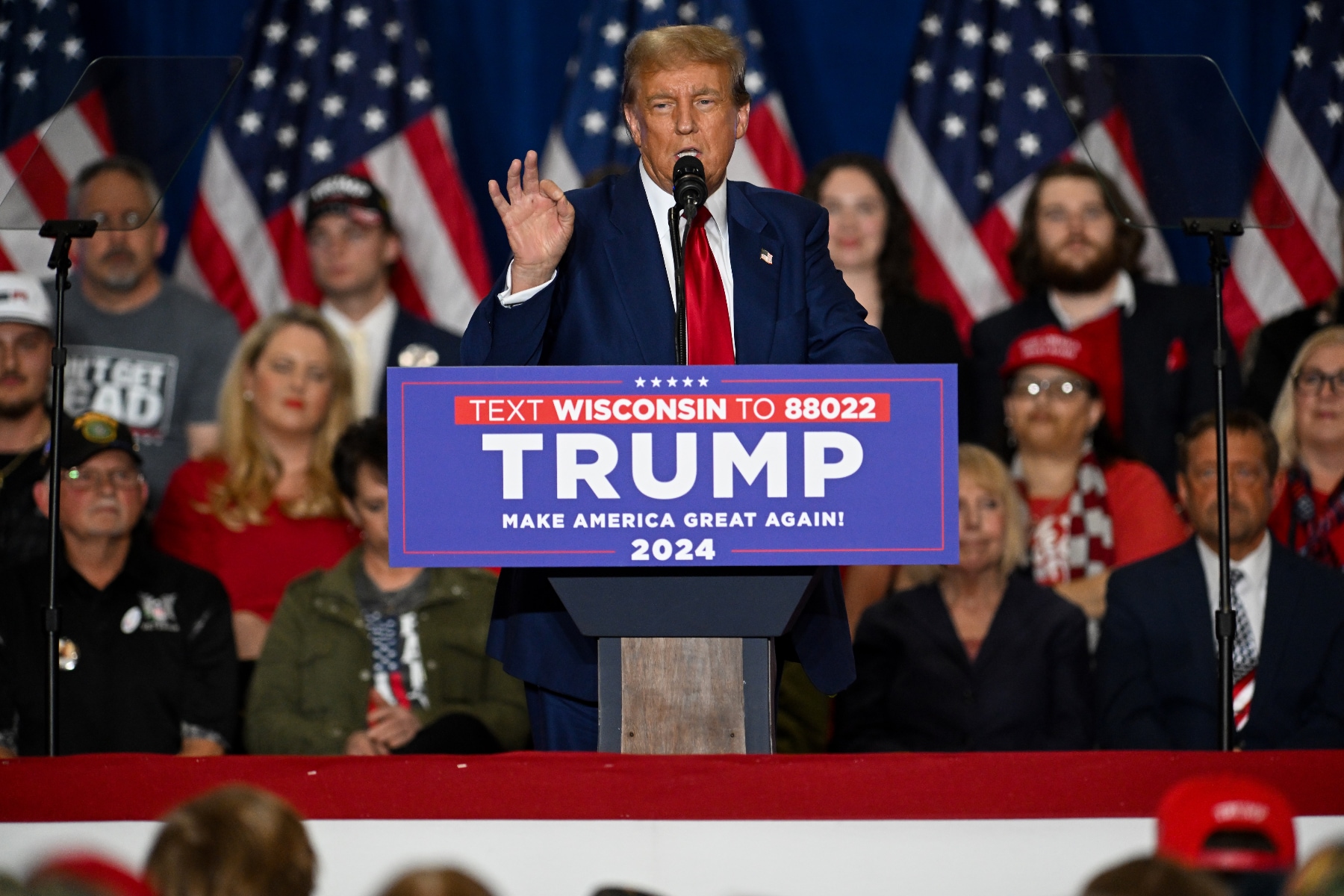 Donald Trump speaks at a campaign rally in Wisconsin on April 2. He's standing behind a lectern with his name on it, with people and American flags in the background