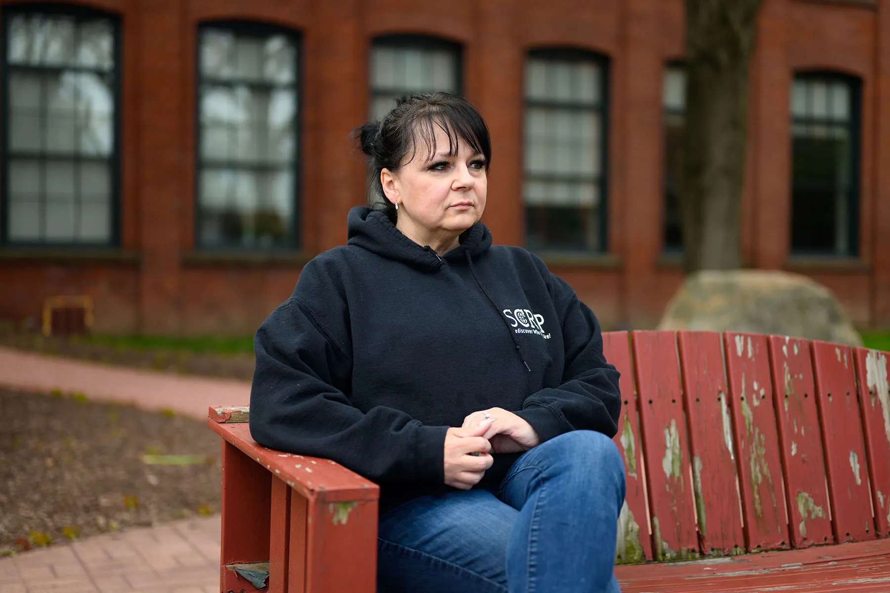 Tracy Shumaker sits for a portrait in front of her office in Hartford, Connecticut.