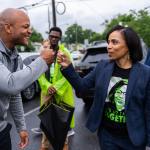 Angela Alsobrooks fist bumps Gov. Wes Moore a they greet voters