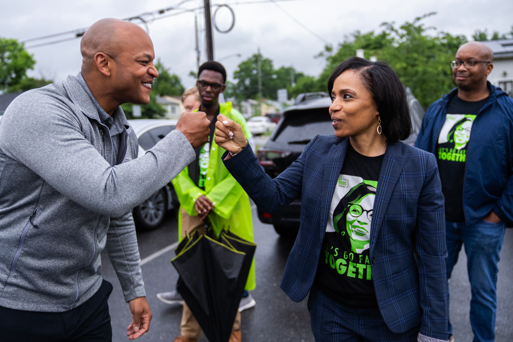 Angela Alsobrooks fist bumps Gov. Wes Moore a they greet voters