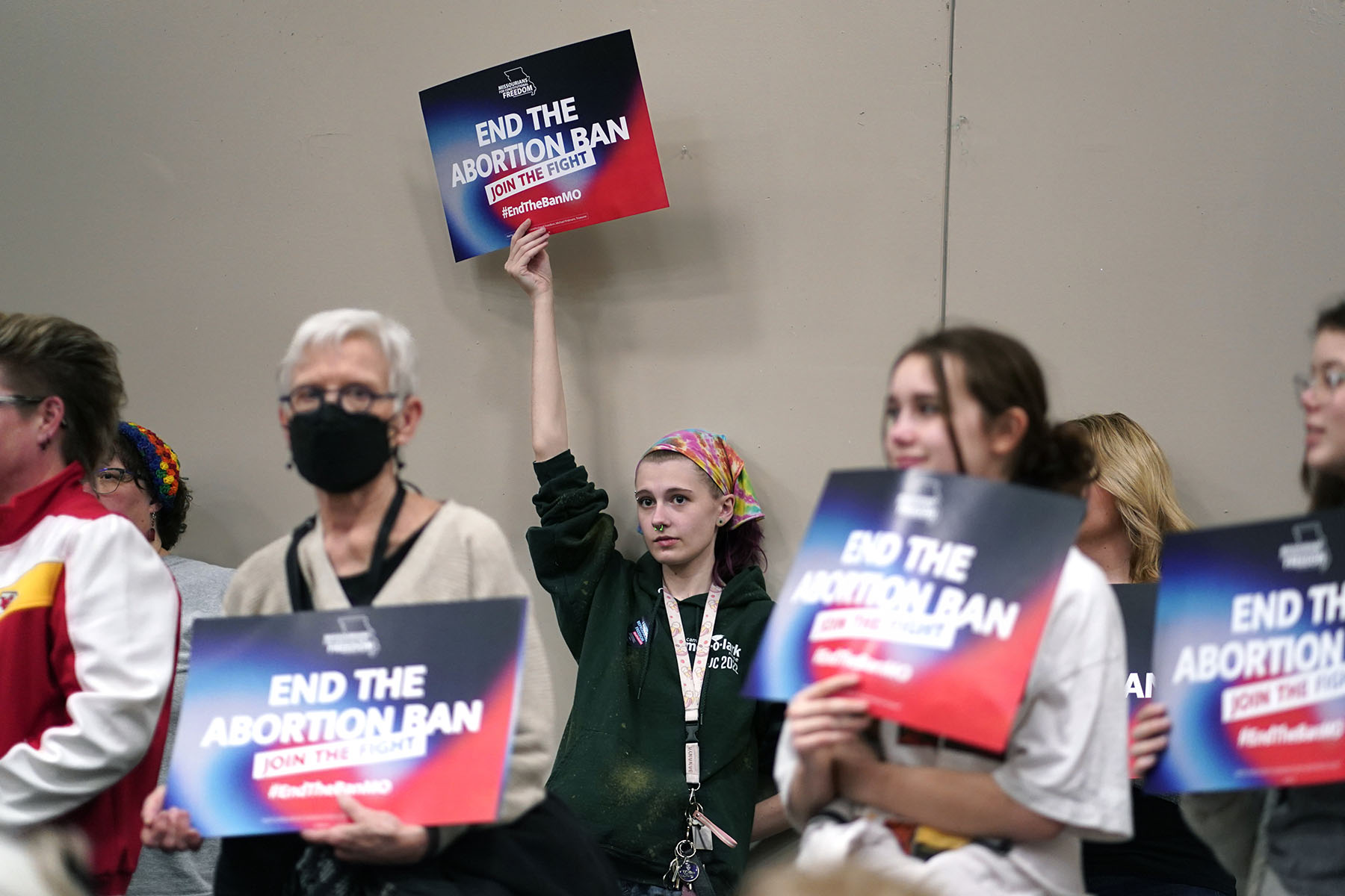 A supporter holds up a sign that reads "end the abortion ban: join the fight" during Missourians for Constitutionals Freedom kick-off petition drive.