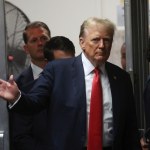 Former President Donald Trump waves to a crowd as he enters the court building in Manhattan.