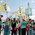 Abortion rights advocates protest outside the Supreme Court. They hold banners that read 