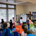 Young children, ages three to five participate in morning warm-up at at child care center.