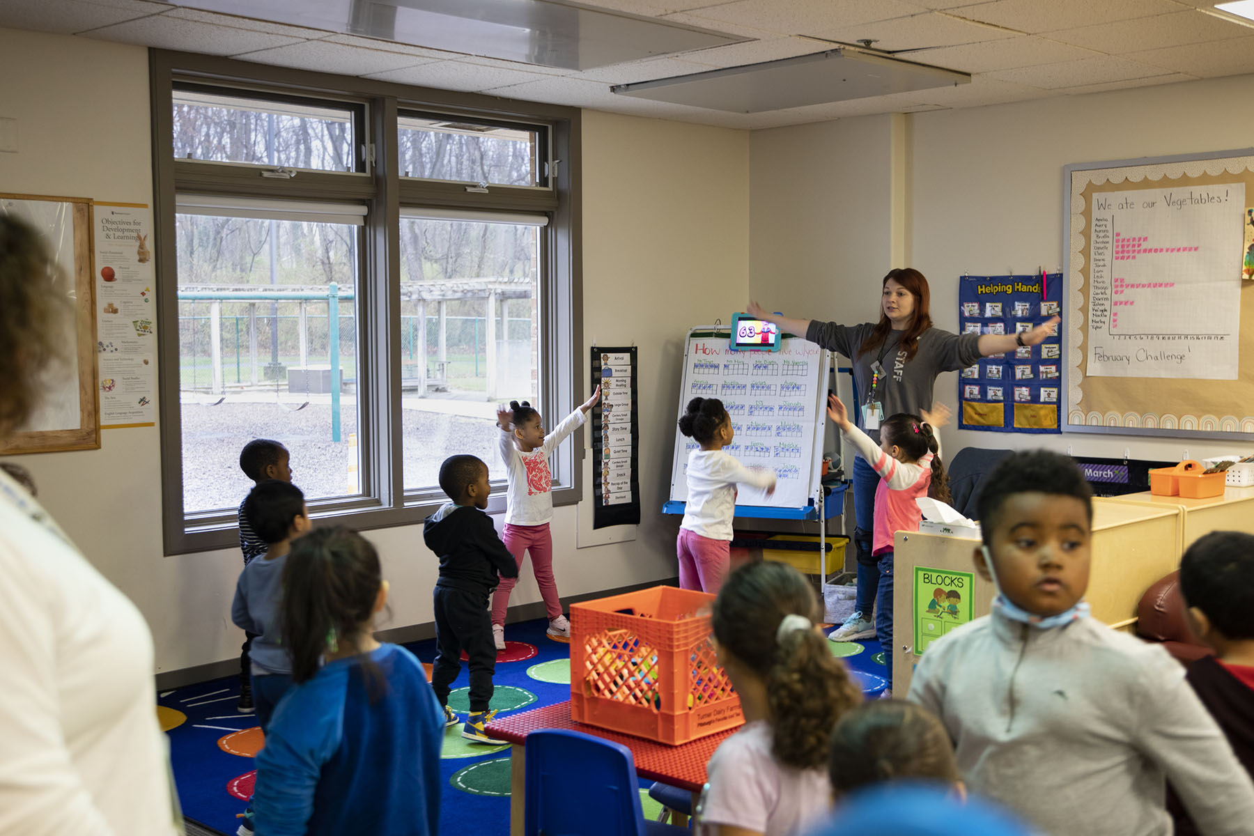 Young children, ages three to five participate in morning warm-up at at child care center.