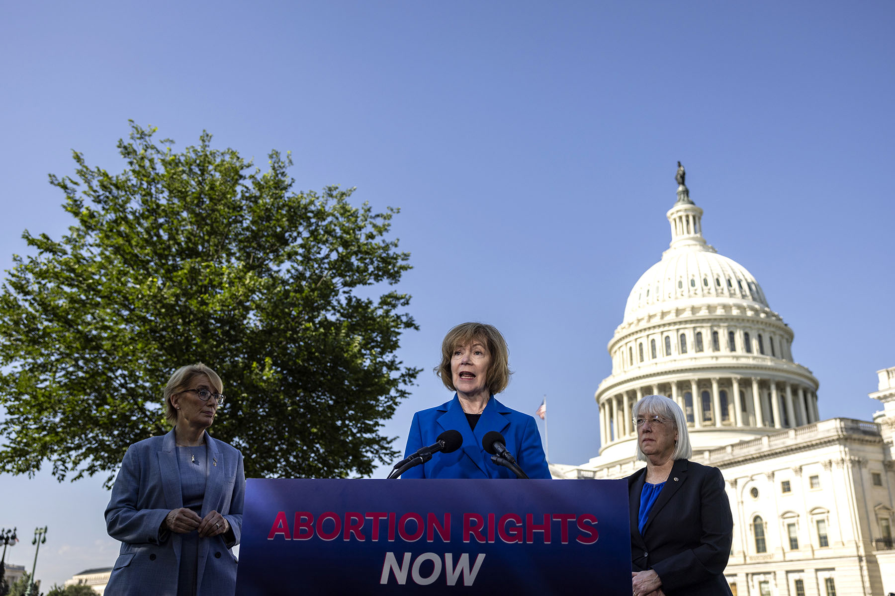 Sen. Tina Smith speaks during a press conference with Sens. Maggie Hassan and Patty Murray in front of the Capitol.