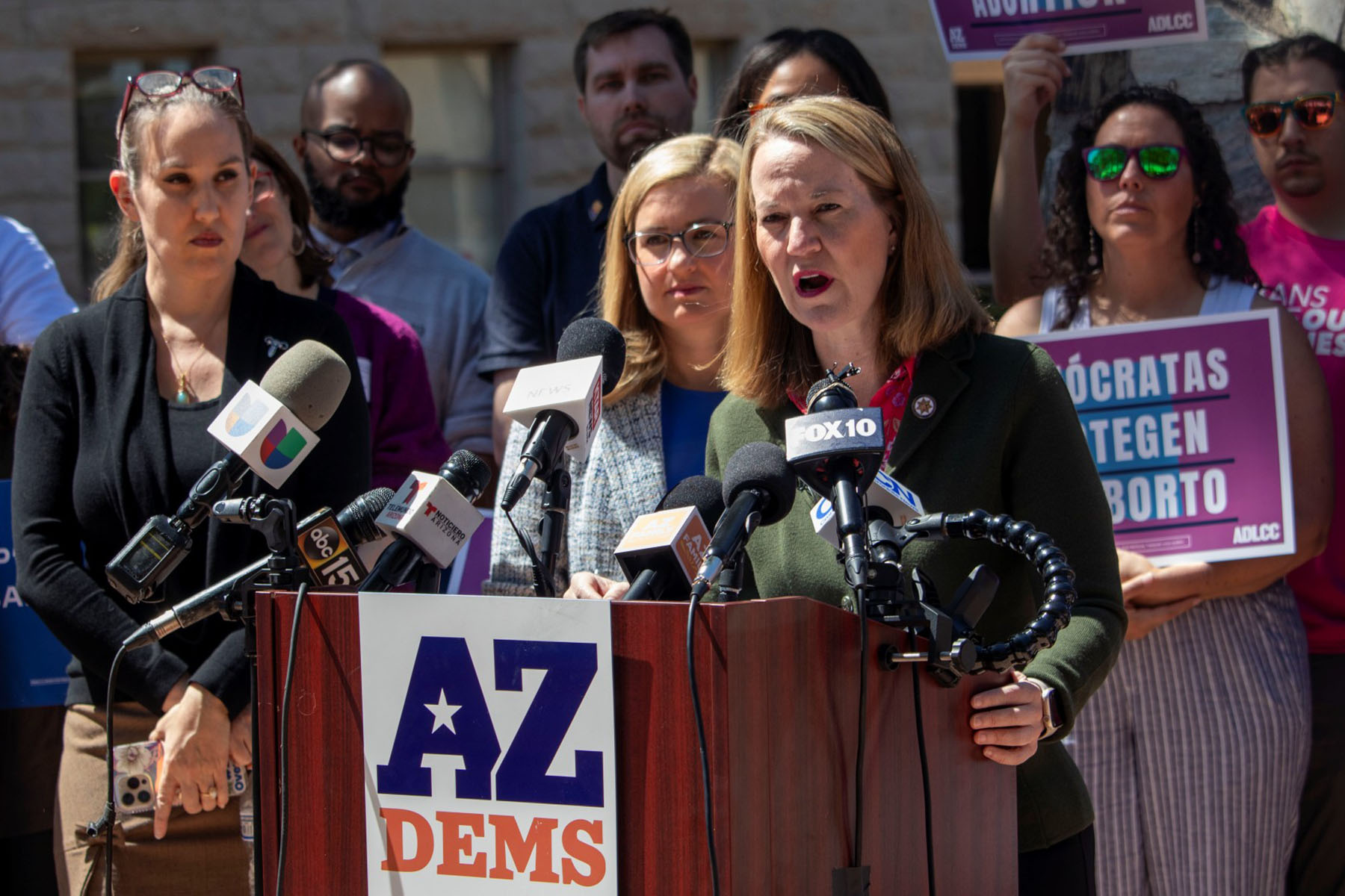 Arizona Attorney General Kris Mayes speaks at a podium during a press briefing.