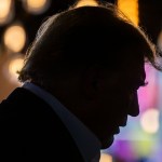 Trump's silhouette is seen as he arrives at a rally at the Iowa State Fair.