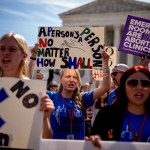 A group of anti-abortion supporters rally in front of the Supreme Court on June 20, 2024 in Washington, D.C. Signs read 