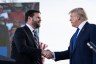 JD Vance shakes hands with former President Donald Trump during a rally.