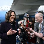 Vice President Kamala Harris speaks to reporters in front of Air Force Two.