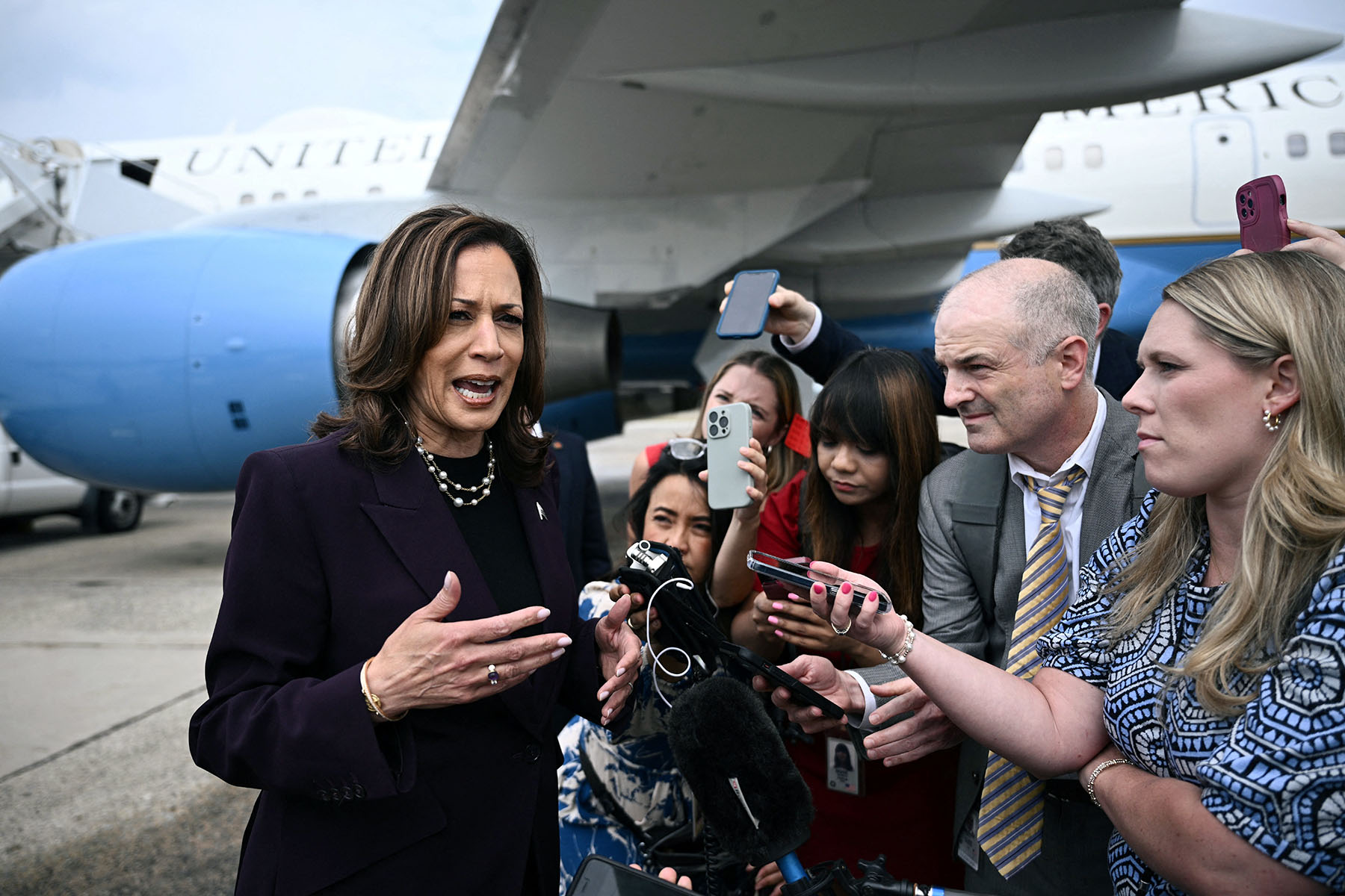 Vice President Kamala Harris speaks to reporters in front of Air Force Two.