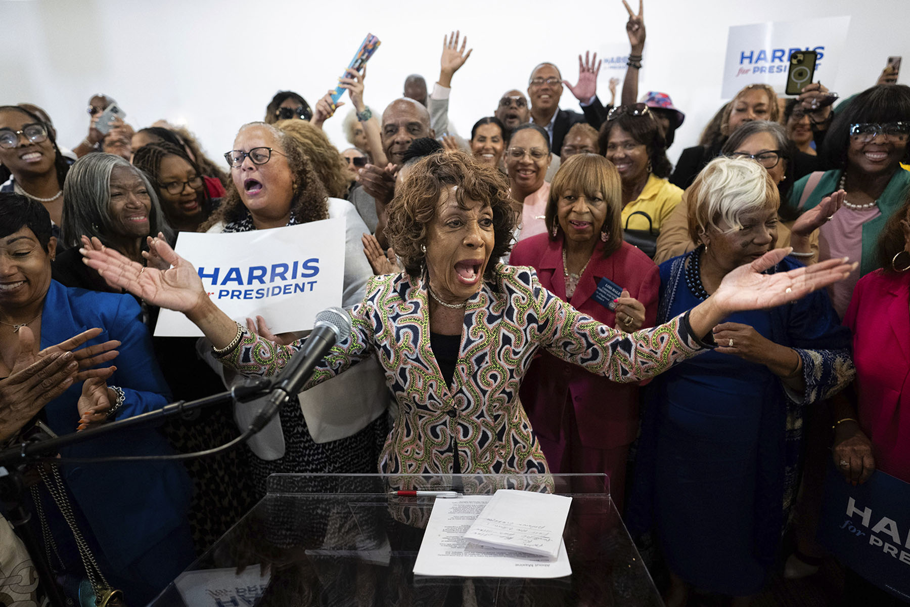 Rep. Maxine Waters is surrounded by supporters of Kamala Harris at a Los Angeles event.