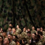 Military personnel and their families wait for President Biden to speak at Fort Liberty.