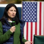 Michigan Attorney General Dana Nessel speaks in front of an American flag.