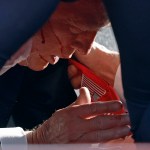 Secret Service tend to republican former President Donald Trump onstage at a rally. Blood is seen on the former president's face.