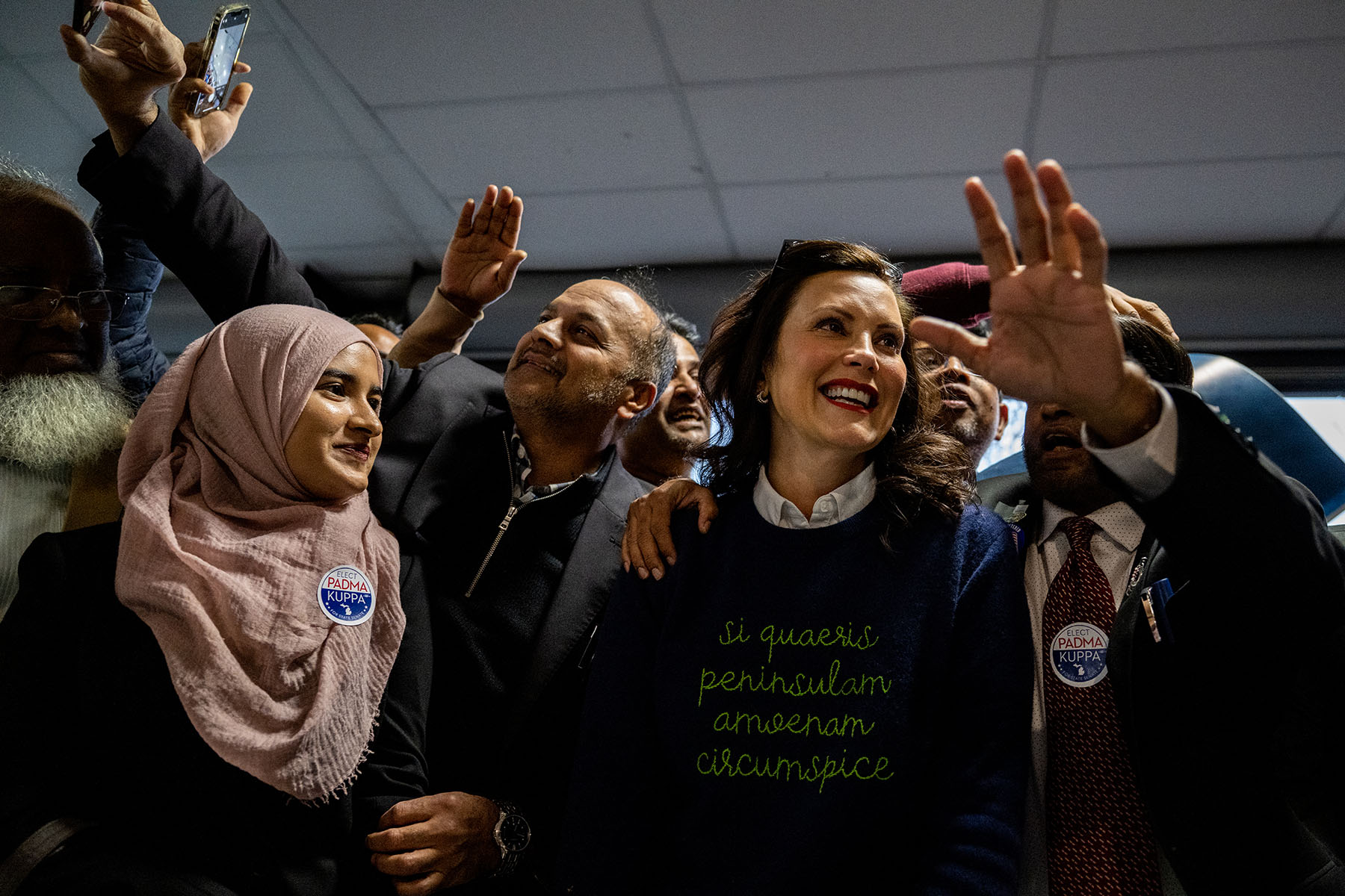 Michigan Gov. Gretchen Whitmer takes pictures with supporters at the end of a campaign rally.