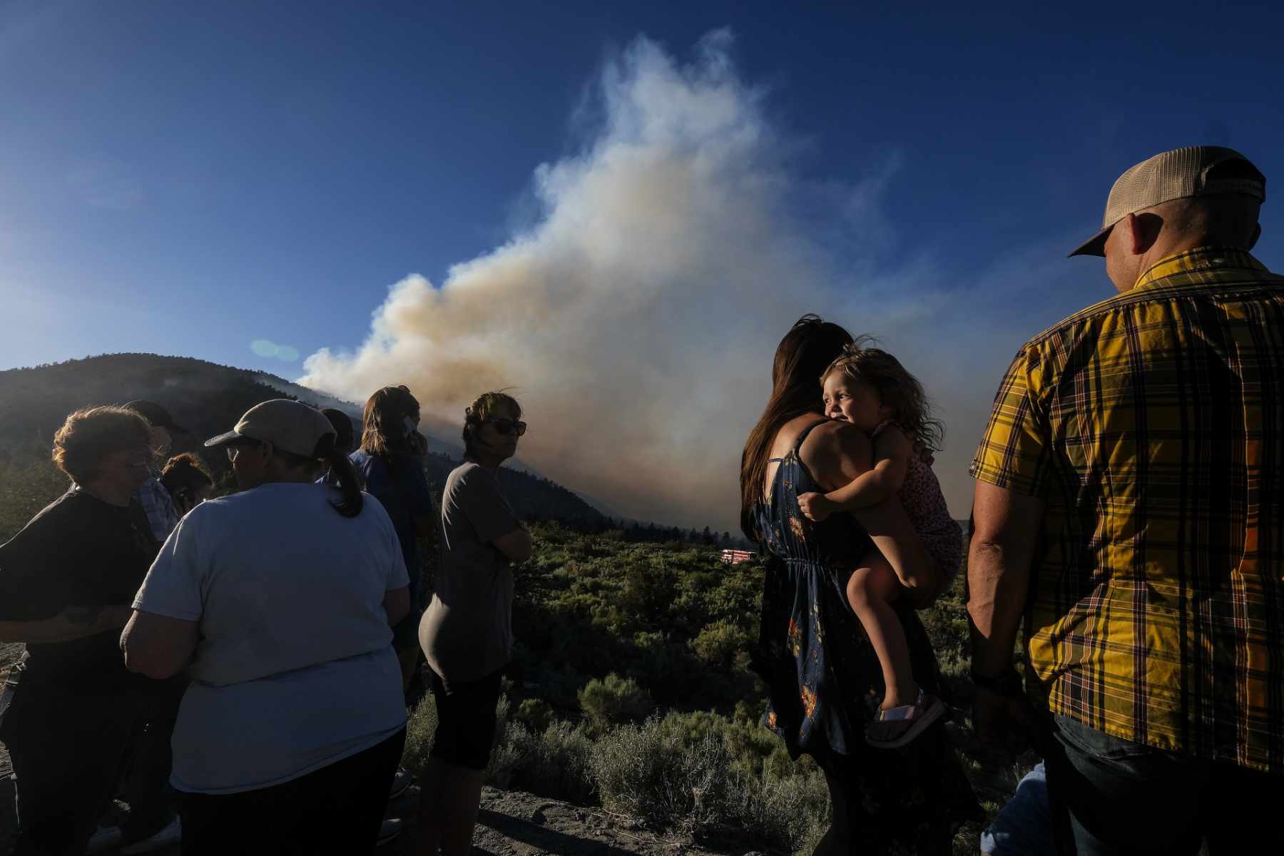 Residents watch as the Sheep fire burns in Wrightwood, Calif., Sunday, June 12, 2022.