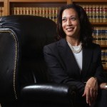 Kamala Harris poses for a portrait in front of law books.