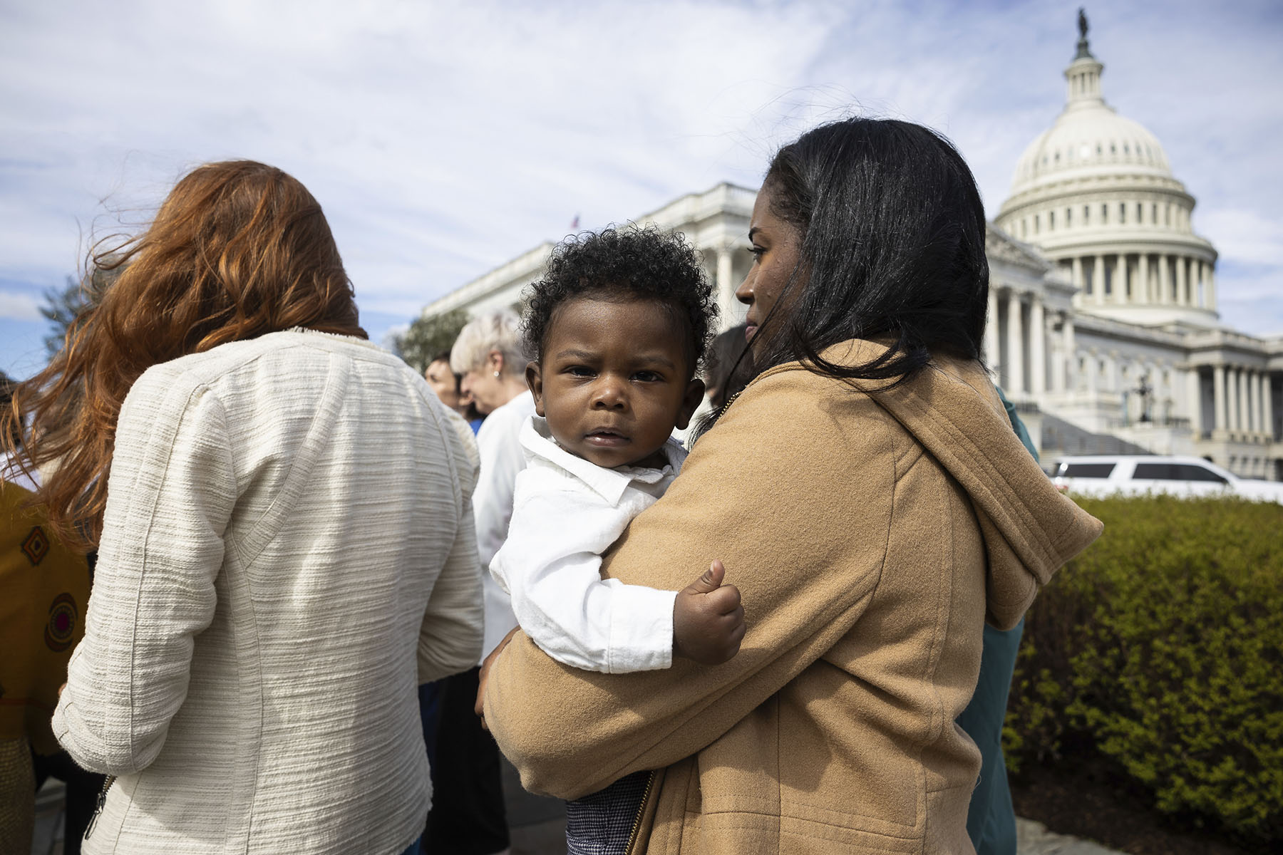 Kaitlyn Joshua holds her son, Liam Joshua, during a press conference with Democratic lawmakers on reproductive freedom outside the Capitol.