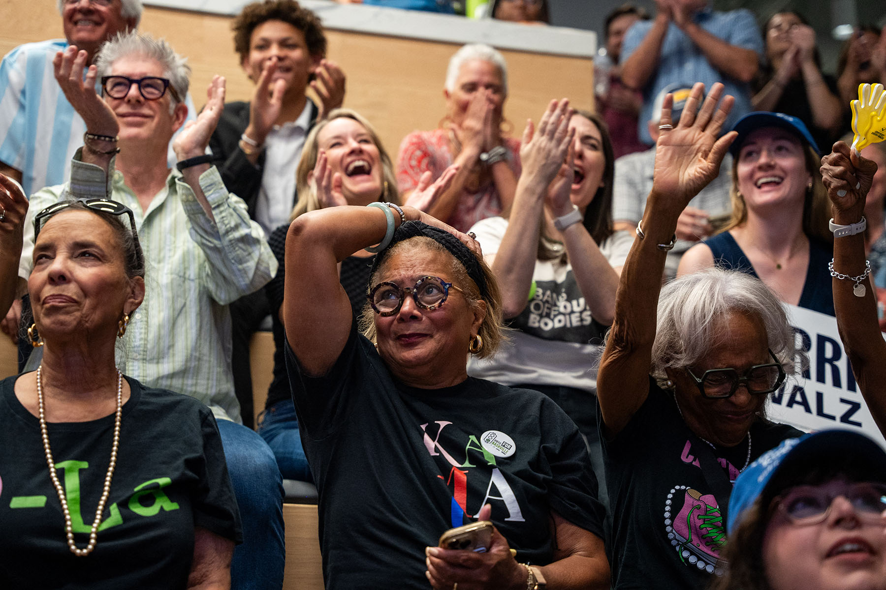 Group of Harris supporters reacting emotionally during a watch party for the 2024 presidential debate.