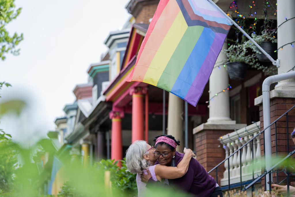 State Sen. Mary Washington, who represents parts of the city and county, is shown hugging a resident of Baltimore's Abell community.