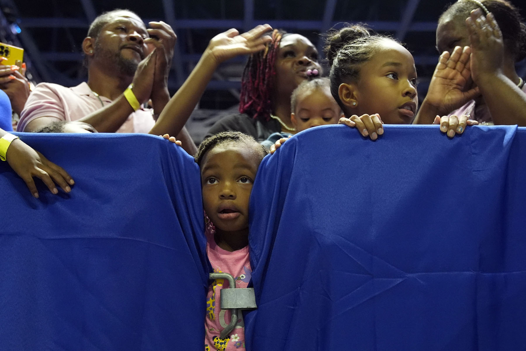 People, including children, listen as Vice President Kamala Harris speaks at a campaign rally in Savannah, Georgia.