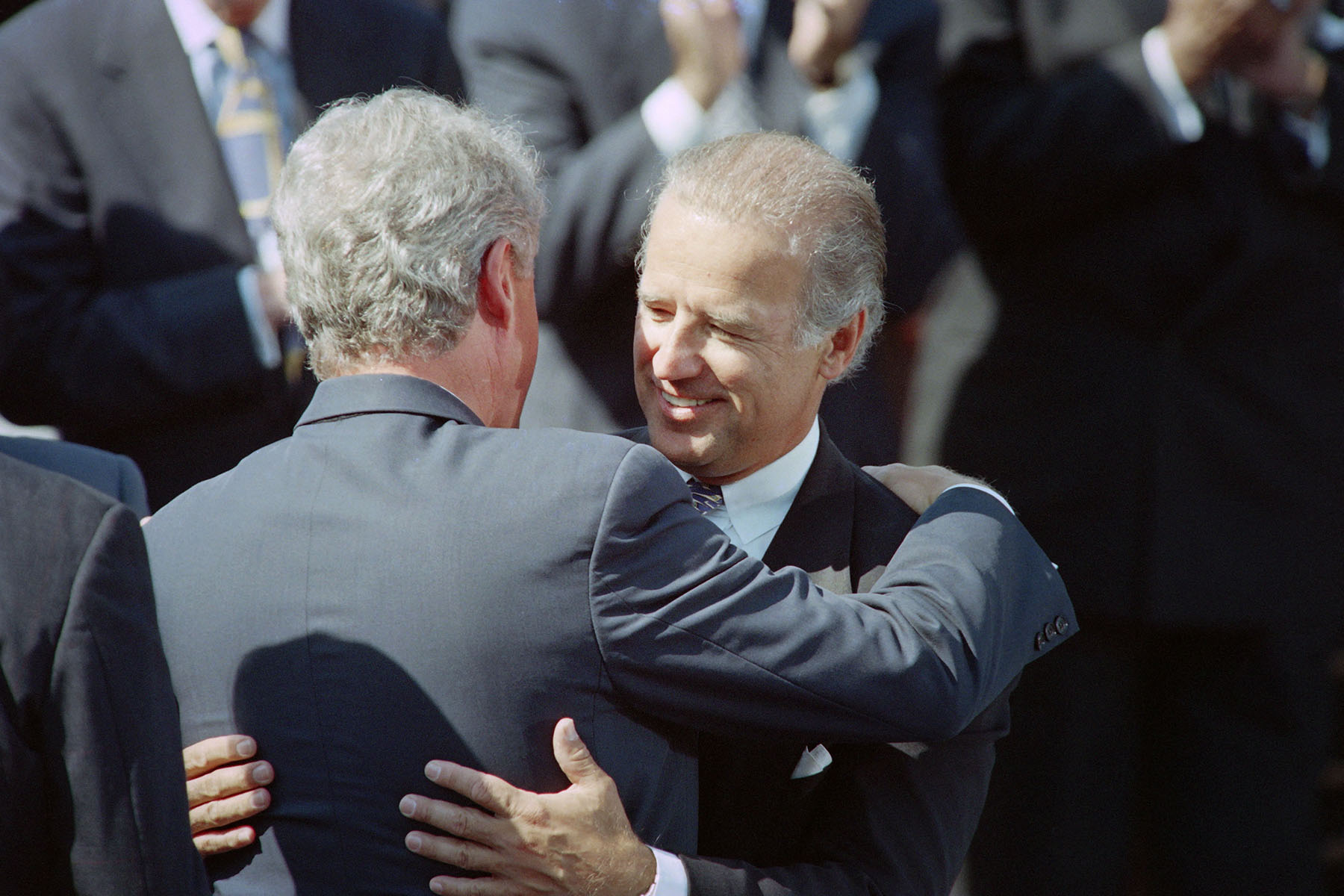 President Bill Clinton hugs Senator Joe Biden during a signing ceremony for the crime bill on the South Lawn of the White House.