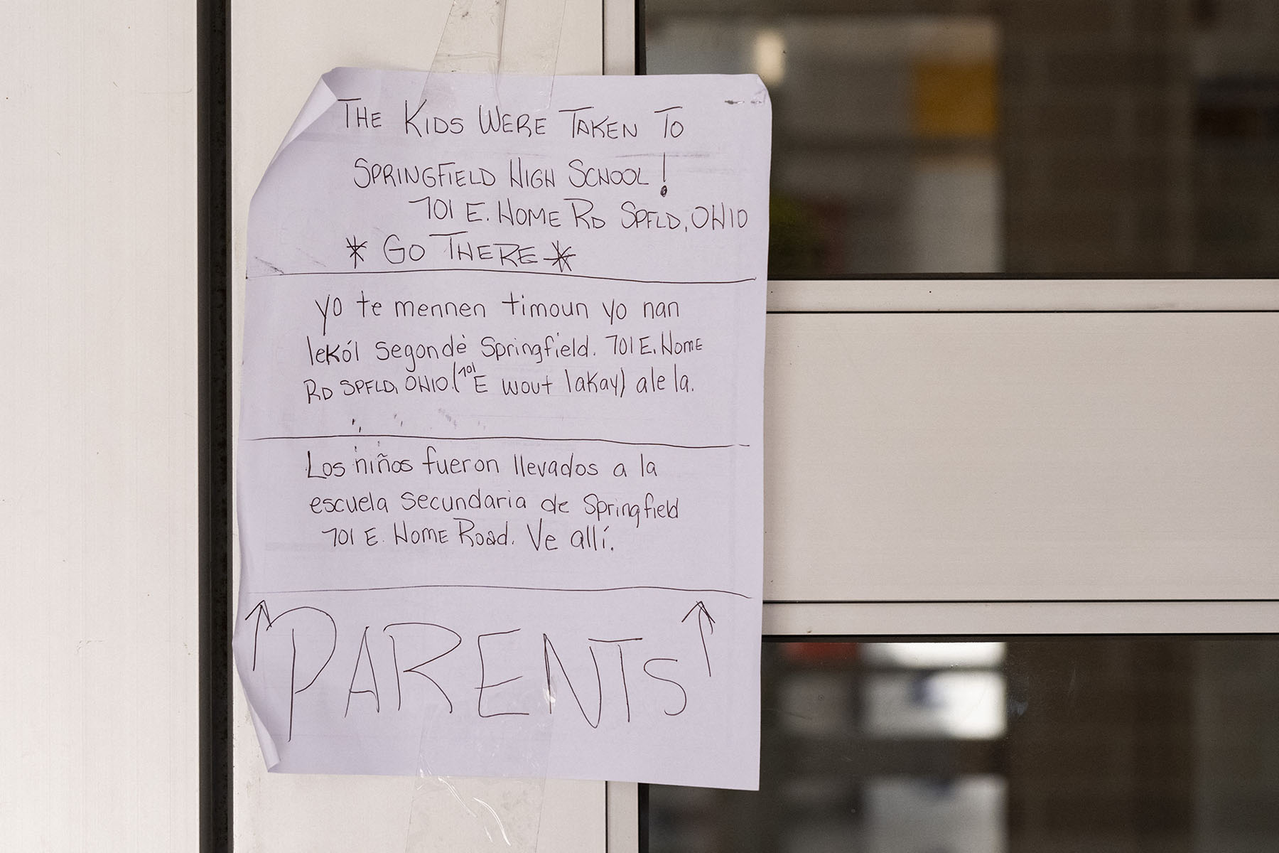 A note on the front door of Fulton Elementary School directs parents to a nearby school for pick-up after the building was evacuated due to bomb threats earlier in the day.