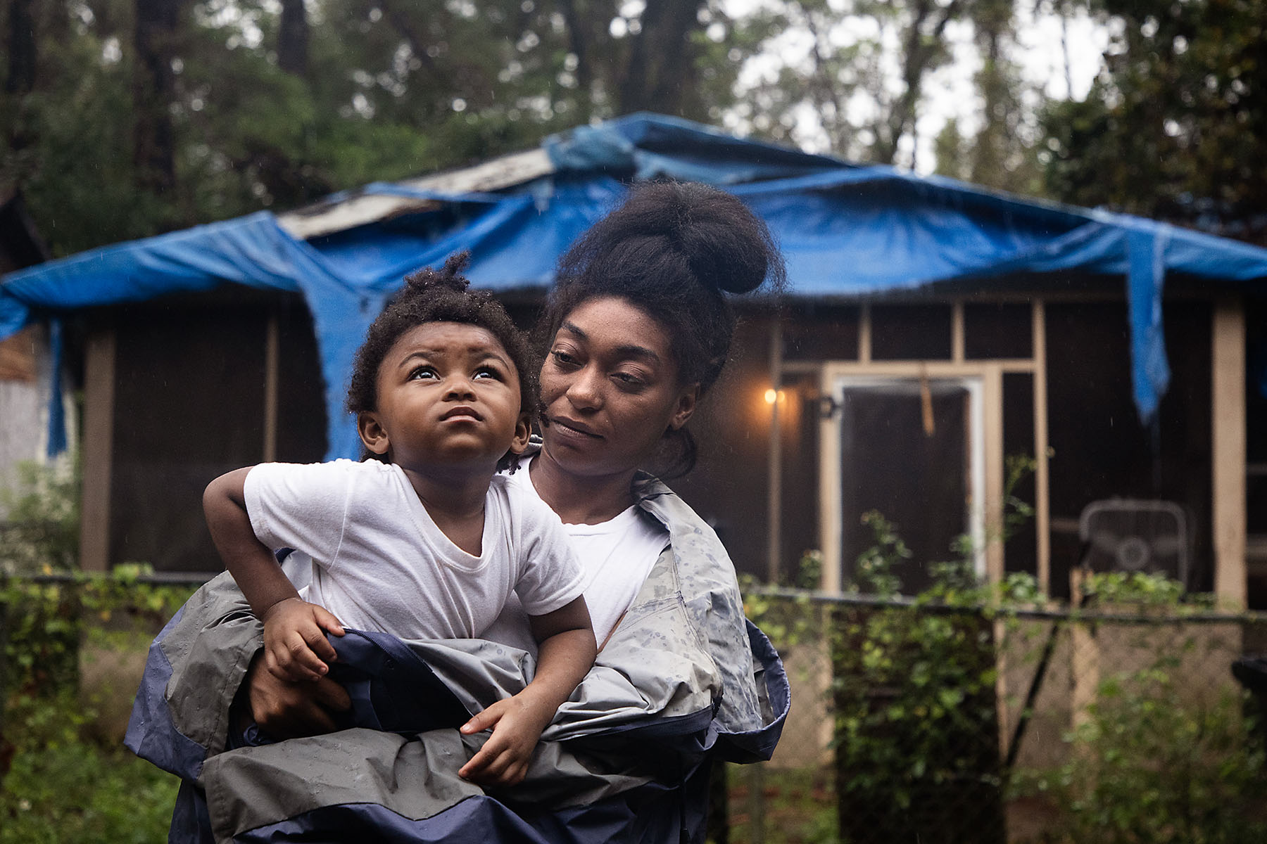 Janika Young holds her son A'King Hart, 2, in Tallahassee, Florida outside of their already damaged home.