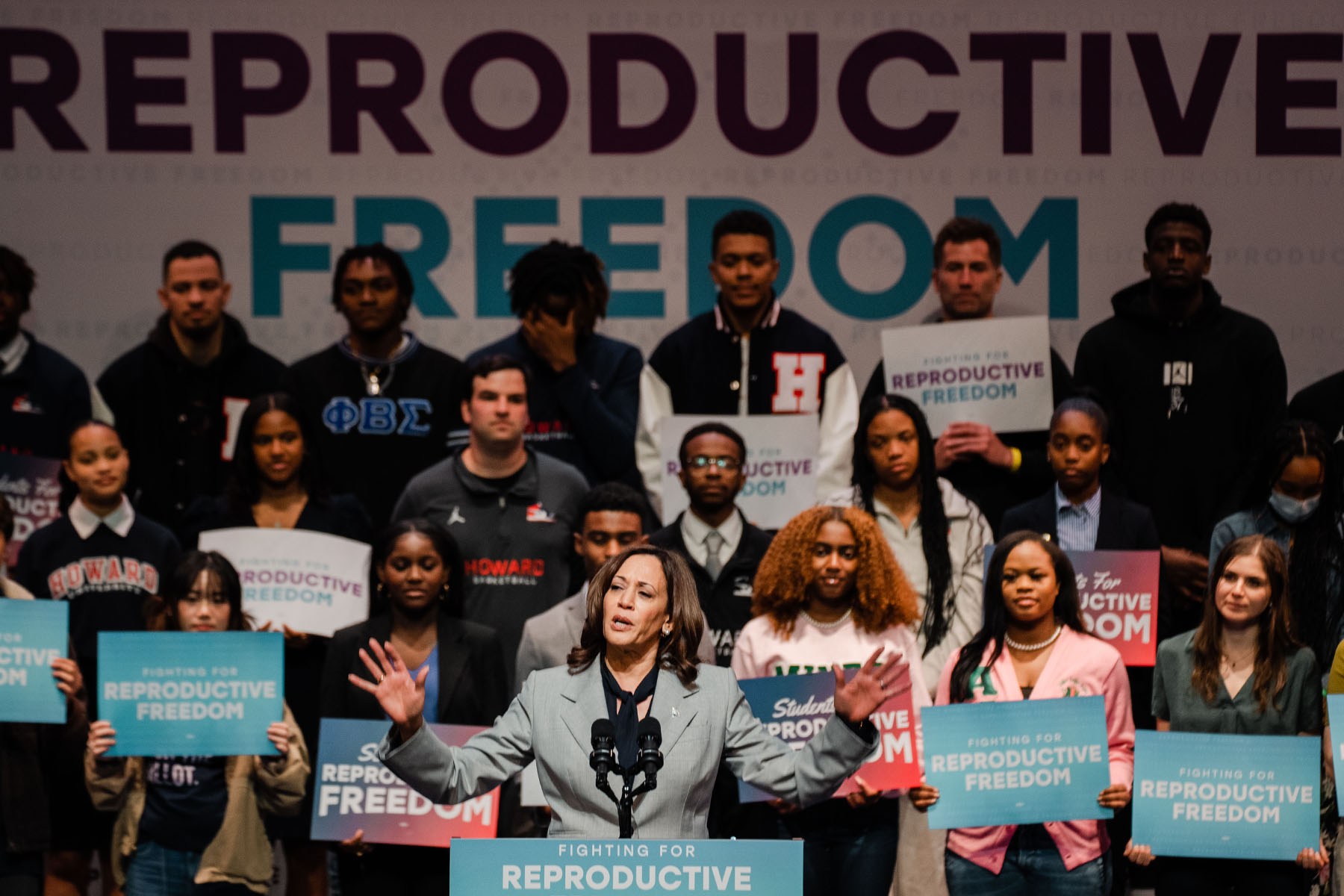 Vice President Harris speaks at a Rally for Reproductive Rights at Howard University. Students hold signs that read Fighting for Reproductive Freedom behind her on stage.