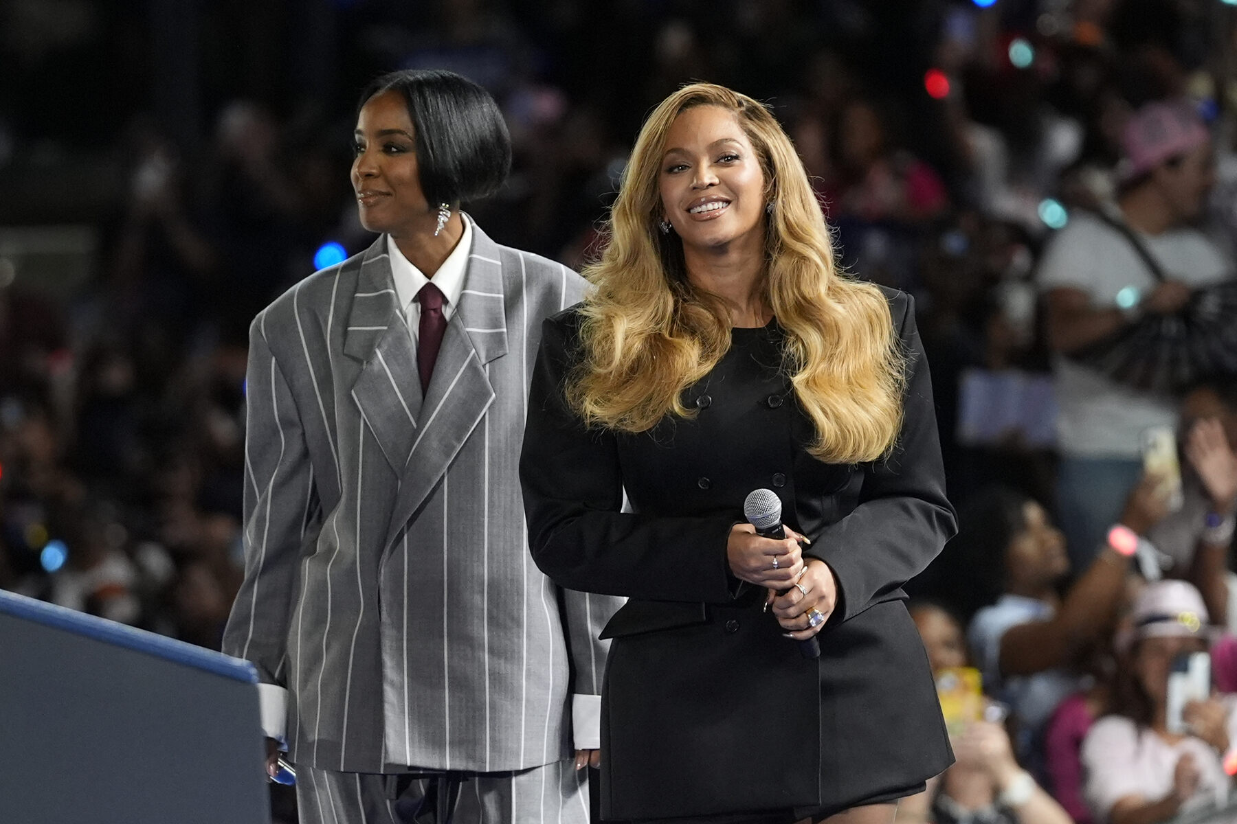 Two women, musical artists Beyoncé and Kelly Rowland on stage at a campaign event for Democratic presidential nominee Vice President Kamala Harris.