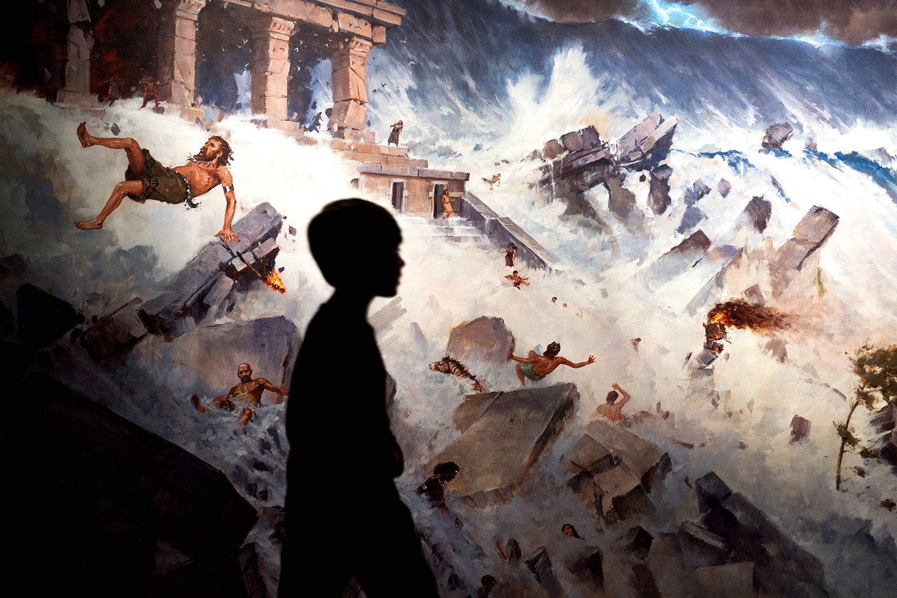 A silhouette of a child walking in front of a mural showing a chaotic scene of people being swept away by floodwaters and ruins of ancient structures collapsing.