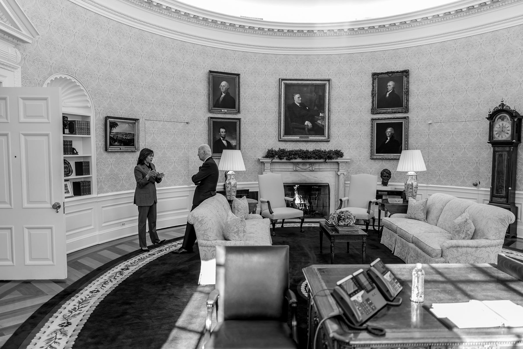 President Joe Biden talks with Vice President Kamala Harris in the Oval Office.