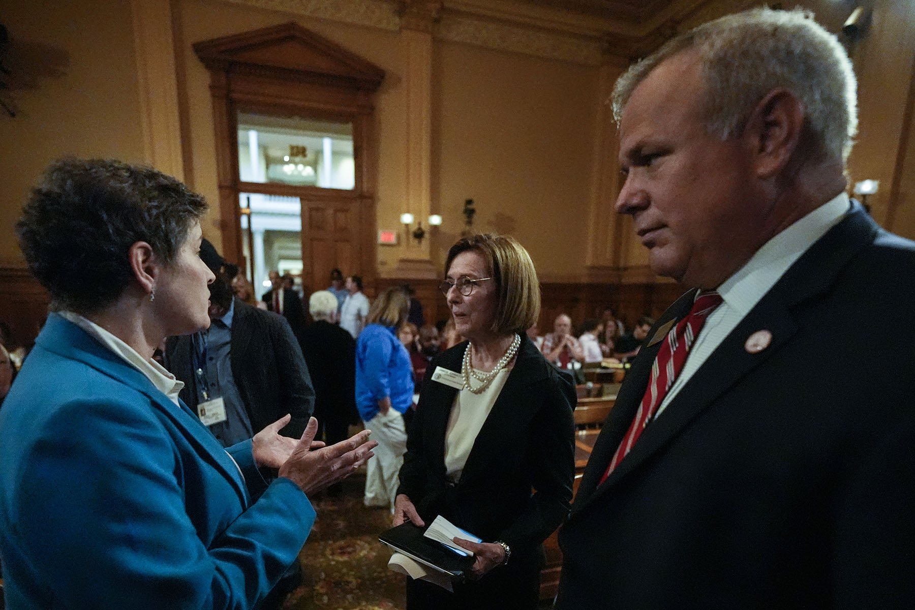 Georgia state election board members Sara Tindall Ghazal, Janice Johnston and Executive Director Mike Coan speak ahead of a Georgia state election board meeting at the state capitol.