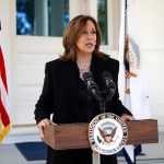 Vice President Kamala Harris stands at a podium as she delivers remarks on former White House Chief of Staff John Kelly's recent comments about former President Trump.