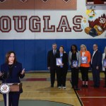 Vice President Harris speaks to the media about gun safety measures as family members hold portraits of loved ones killed during the 2018 shooting at Marjory Stoneman Douglas High.