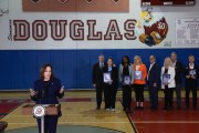 Vice President Harris speaks to the media about gun safety measures as family members hold portraits of loved ones killed during the 2018 shooting at Marjory Stoneman Douglas High.