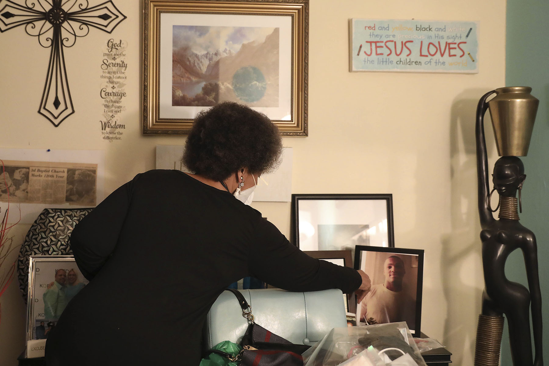 Mattie Scott points out a framed photo of her son at her home in San Francisco, California.